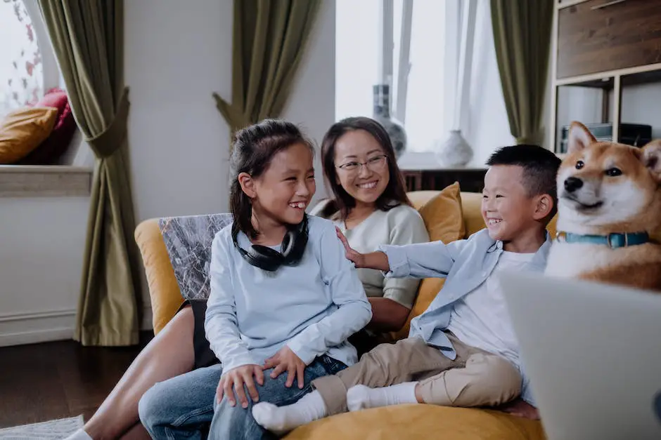 A cute and friendly dog sitting on a couch next to a happy family.